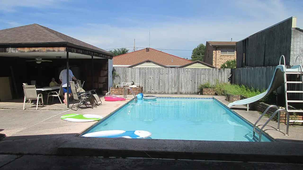 Backyard pool beside a family home